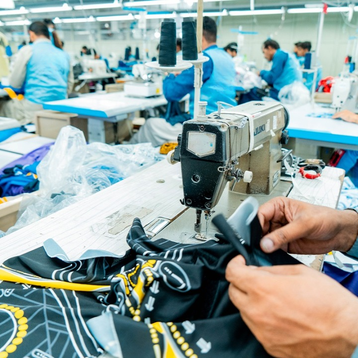 Stitching stage of Ambition Sports custom sportswear manufacturing process